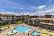 Thumbnail 16 of 38 - Broomfield, CO Apartments - Terracina - Aeriel view of Pool with jacuzzi, Umbrella Seating Areas, and Large Fountain