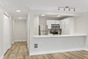 Thumbnail 38 of 57 - a kitchen with white cabinetry and a white counter top and stainless appliances