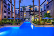 Thumbnail 19 of 21 - Phoenix AZ Apartments- Exterior View of the Back of Level at Sixteenth Building Featuring Pool Lit at Night