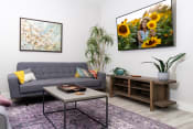 Thumbnail 7 of 84 - mihir taylor model living room with a couch and a table and a picture of sunflowers