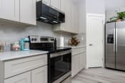 Thumbnail 9 of 84 - Mihir Taylor model kitchen with stainless steel appliances and white cabinets