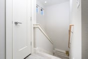 Thumbnail 16 of 84 - the landing of a staircase in a home with white walls and a door