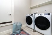 Thumbnail 17 of 84 - a washer and dryer in a laundry room with a mirror and a door