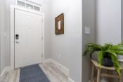 Thumbnail 24 of 84 - mihir taylor model entryway with a white door and a plant on a stool