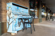 Thumbnail 32 of 84 - a piano outside of a restaurant with a chair