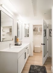 Thumbnail 7 of 38 - a bathroom with white cabinets