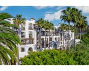 Thumbnail 4 of 88 - exterior building of promenade rio vista apartments and palm tree lush landscaping