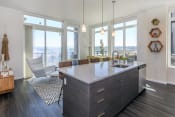Thumbnail 21 of 24 - an open kitchen with a large island and a view of the city at Napoleon Apartments, Washington, 98402