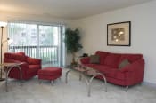 Thumbnail 27 of 46 - a living room with a red couch and chair and a sliding glass door