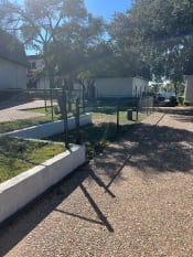 Thumbnail 9 of 14 - a fenced in yard with a chain link fence and a house in the background