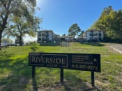 Thumbnail 4 of 6 - a view of riverside view apartments from the street with a sign