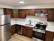 Thumbnail 35 of 35 - a kitchen with stainless steel appliances and wooden cabinets