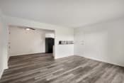 Thumbnail 3 of 14 - an empty living room with white walls and wood floors