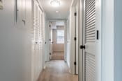 Thumbnail 22 of 35 - a hallway with white shutters and a light on the ceiling