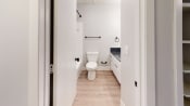 Thumbnail 28 of 35 - a renovated bathroom with white walls and wood floors