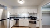 Thumbnail 17 of 35 - a kitchen with white cabinets and stainless steel appliances