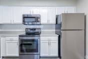 Thumbnail 8 of 24 - Renovated kitchen with stainless steel appliances