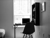 Thumbnail 16 of 33 - a black and white photo of a desk with a laptop