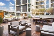 Thumbnail 5 of 28 - Pet-Friendly Apartments in Hollywood CA - The Fifty Five Fifty - Grill Area with Outdoor Lounge Seating