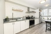 Thumbnail 2 of 33 - a kitchen with white cabinets and stainless steel appliances