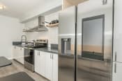 Thumbnail 4 of 33 - a kitchen with white cabinets and stainless steel appliances