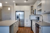 Thumbnail 2 of 48 - a kitchen with white cabinets and stainless steel appliances