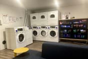 Thumbnail 7 of 33 - a laundry room with washers and dryers