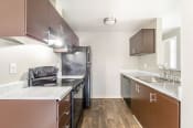 Thumbnail 7 of 16 - a kitchen with dark cabinets and white countertops