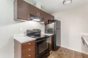 Thumbnail 6 of 16 - a kitchen with brown cabinets and stainless steel appliances