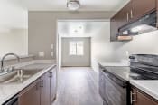 Thumbnail 8 of 16 - a kitchen with stainless steel appliances and white quartz countertops