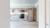 Thumbnail 2 of 12 - a kitchen with white cabinets and stainless steel appliances