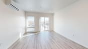 Thumbnail 8 of 12 - an empty living room with white walls and wood floors