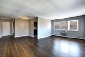 Thumbnail 11 of 16 - a living room with hardwood floors and grey walls