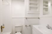 Thumbnail 7 of 20 - a white bathroom with a toilet and a sink
