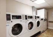 Thumbnail 19 of 20 - a row of washing machines in a laundromat