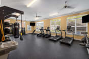 Thumbnail 11 of 14 - an exercise room with treadmills and other fitness equipment