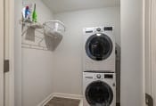 Thumbnail 15 of 41 - a washer and dryer in a small laundry room