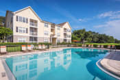 Thumbnail 5 of 23 - The Colony at Deerwood Apartments - Resort-style swimming pool with lounge area