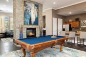 Thumbnail 5 of 22 - Cordillera Ranch Apartments billiards table and indoor fireplace