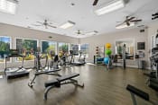 Thumbnail 6 of 25 - a gym with exercise equipment and windows