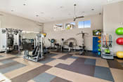 Thumbnail 10 of 26 - First and Main Apartments fitness center weight machines and exercise balls