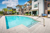 Thumbnail 12 of 26 - Centre Pointe Apartments resort-style pool area with surrounding sundeck