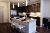 Thumbnail 12 of 19 - The Juncture Apartments brown kitchen cabinets