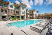 Thumbnail 13 of 26 - Centre Pointe Apartments resort-style pool area with surrounding sundeck