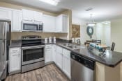 Thumbnail 15 of 23 - The Colony at Deerwood Apartments - Open kitchens with stainless steel appliances