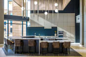 Thumbnail 9 of 75 - barstools around a counter in an indoor kitchen at The Apex at CityPlace, Overland Park, KS, 66210