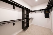 Thumbnail 35 of 75 - the inside of a large empty walk-in closet with carpeted floors at The Apex at CityPlace, Overland Park, KS