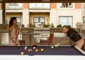 Thumbnail 43 of 56 - Couple playing pool at The Residences at Galleria