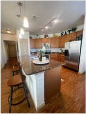 Thumbnail 22 of 31 - a kitchen with stainless steel appliances and a granite counter top