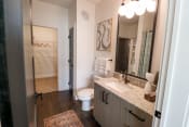Thumbnail 6 of 41 - The Wren 1 bedroom model apartment home bathroom with granite countertop vanity located in Lawrenceville, GA